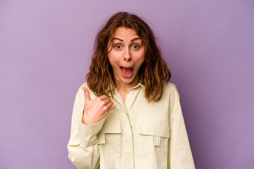 Young caucasian woman isolated on purple background laughing about something, covering mouth with hands.