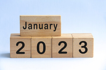 January 2023 text on wooden blocks with white color background. Copy space