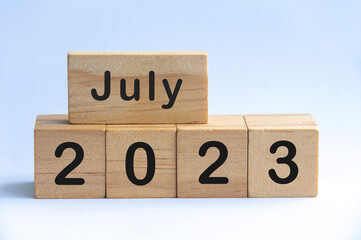 July 2023 text on wooden blocks with white color background. Copy space