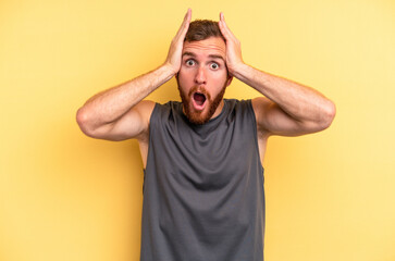 Fototapeta na wymiar Young caucasian man isolated on yellow background surprised and shocked.