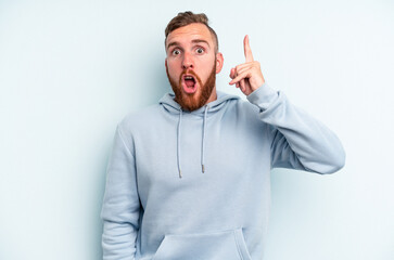 Young caucasian man isolated on blue background having some great idea, concept of creativity.