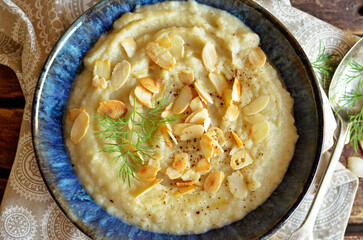 Cream soup with parsley in a blue bowl