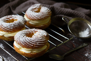 Custard rings with cheese wipped cream -homemade baking background. Paris Brest custard cakes. Baking recipe layout
