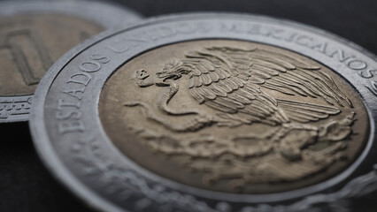 Coin 5 Mexican pesos close up. Peso of Mexico. Reverse of coin with coat of arms of country. Eagle and snake. Low saturation money wallpaper. News about economy or business. Loan and credit. Macro