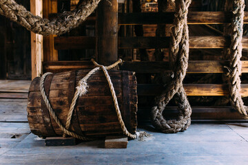 Wooden winch of a sailing ship and ropes on the deck of medieval pirate warship
