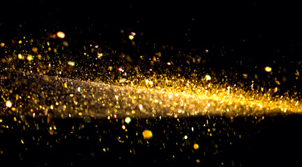 Golden Christmas and New Year glittering stars ray on black bokeh background. backdrop with...