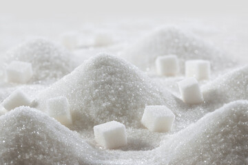White granulated sugar and refined sugar cubes close-up - obrazy, fototapety, plakaty
