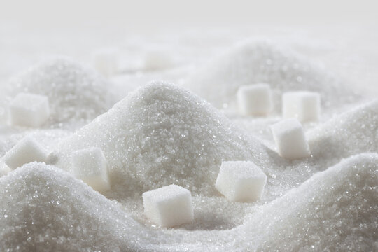 White granulated sugar and refined sugar cubes close-up