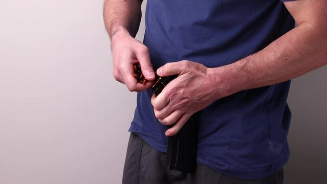 Man loading Kalashnikov assault rifle magazine with cartridges. Load magazine with bullets 7.62 caliber for ak 47