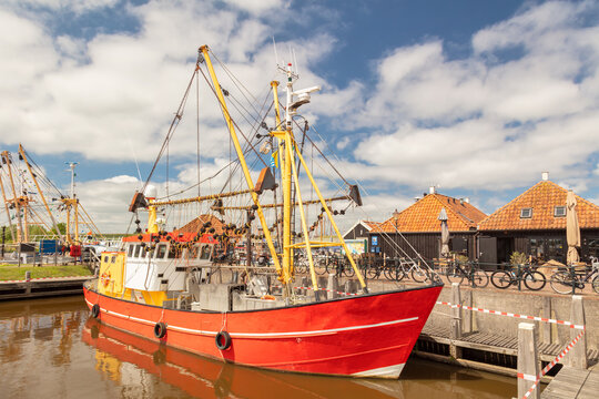 Summer view of the harbor with fishing ship and historic buildings in Zoutkamp, Groningen, The Netherlands