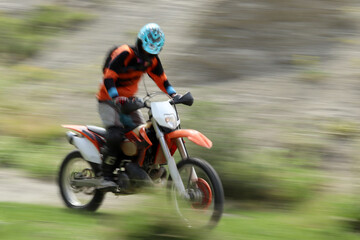 Blurry image of motorcycle riders during motocross race