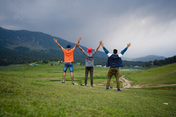 3 friends in the mountains, and photo depicts the peace and heavenly beauty that prevails in the valley of Kashmir which has been engulfed by the terrorism, Gulmarg, Kashmir, India.