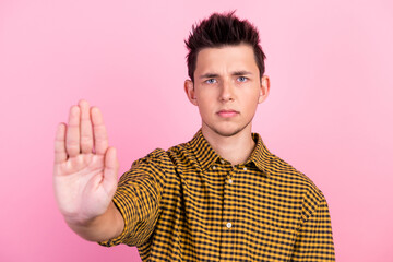 Man over isolated pastel background making stop gesture with his hand