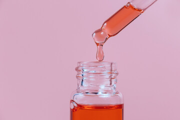 Pipette with a glass bottle on a light background.