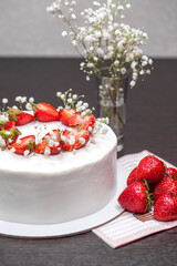 Strawberry homemade cake decorated with gypsophila sprigs