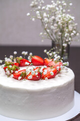 Obraz na płótnie Canvas Strawberry homemade cake decorated with gypsophila sprigs