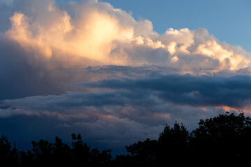 Fototapeta na wymiar Clouds during sunset over the trees