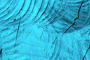 Cyan wood texture. Abstract background. Traces of a circular saw on a tree trunk.