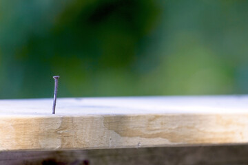 Nail in wooded deck rail