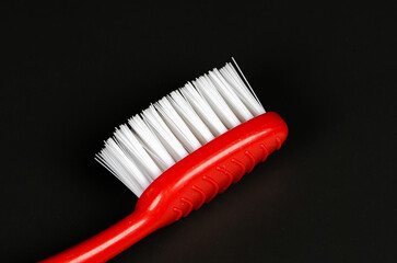 red toothbrush with black background