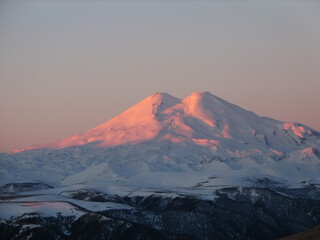 Elbrus is a high mountain. Dormant volcano. mountain covered with snow on blue sky. Caucasus mountains, slopes