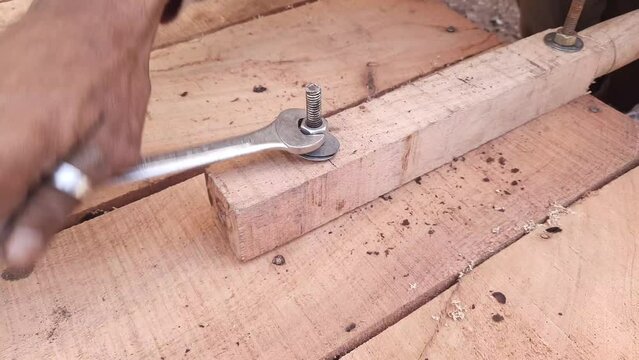 A Carpenter Fixing Handle Of Thela Gadi Wheelbarrow By Nut Bolt Fitting Tools - Nut Bolt Fitting Tools