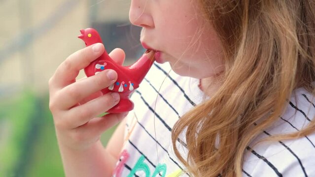 Young Caucasian Girl Blowing Porcelain Bird Whistle Water Whistle Toy Playing High Pitch Vibrating Sound 