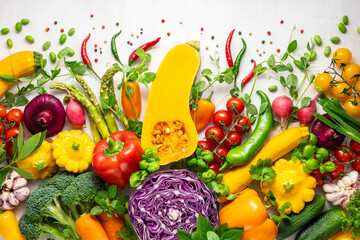 Fresh assorted vegetables and herbs on white background. Healthy clean eating, vegetarian or diet food concept.Food frame.