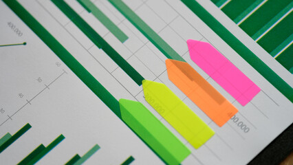Colourful sticker stripes on business documents with charts and graphs