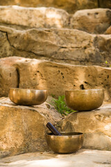 Fototapeta premium Still life with Tibetan bowls on rocks.