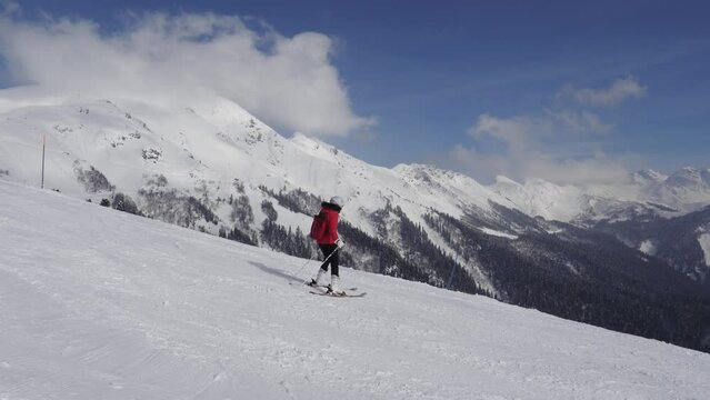 Woman Skier Skiing Down On Ski Slopes On Skis On Sunny Winter Day