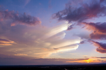 Gorgeous view dramatic orange sunset through the clouds
