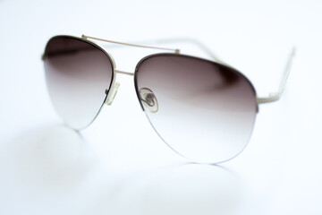 Glasses with gradient filled lenses, aviator glasses on a white background, selective focus