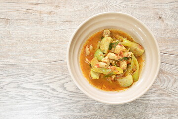 spicy boiled chicken with eggplant in curry soup on bowl