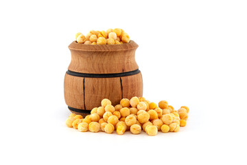 Dry whole yellow peas spilling from wooden barrel