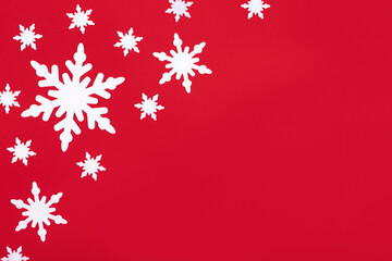 Christmas or winter composition. Pattern of snowflakes on a bright red background. Christmas,...