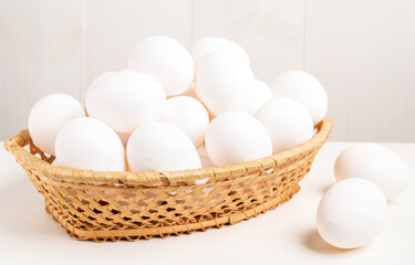Chicken eggs in a wicker basket.