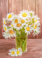 Bouquet of daisies in a glass.