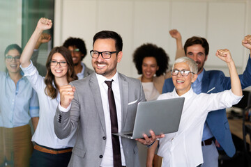 Group of successful multiethnic business people celebrating a good job in the office