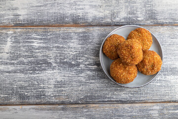 meat balls on a wooden plate on a gray. Top view, copy space.