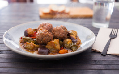 cooked meatballs with stewed eggplant with haze in bowl