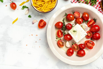 Trend Feta pasta recipe made of cherry tomatoes, feta cheese, garlic and herbs. cooking recipe ingredients, place for text, top view