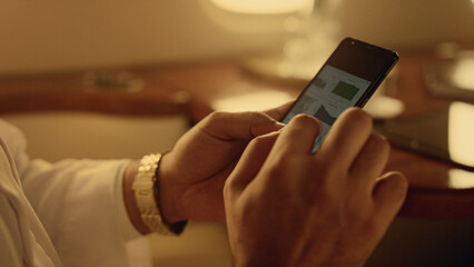 Businessman analyzing smartphone financial graphs. Closeup hands holding phone