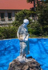 Stone statue of a woman with a jug, in a pool, National Reserve Askania-Nova, Ukraine