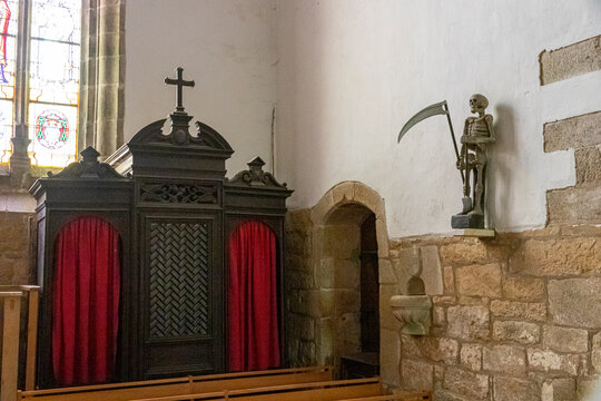 Ploumilliau, France. Statue of the Ankou, a 16th century personification of death at the Church of Saint Milliau