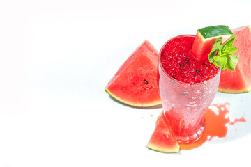 Refreshing cold summer drink watermelon slushie, iced Granita dessert beverage, crushed watermelon ice on trendy high-colored white pink background copy space