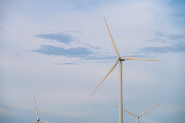 Fototapeta premium Wind turbine generator with blue sky - energy conservation concept. thailand