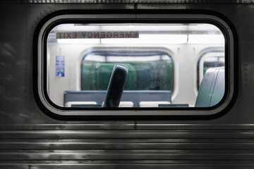 Looking through the window of an empty commuter train car in a dark station in downtown Chicago