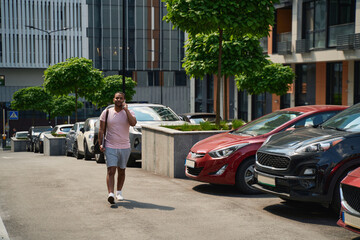 Serious man calling on smartphone in business district