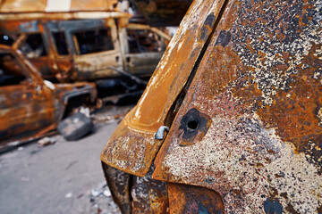 Bullet holes in burned car shell in Ukraine